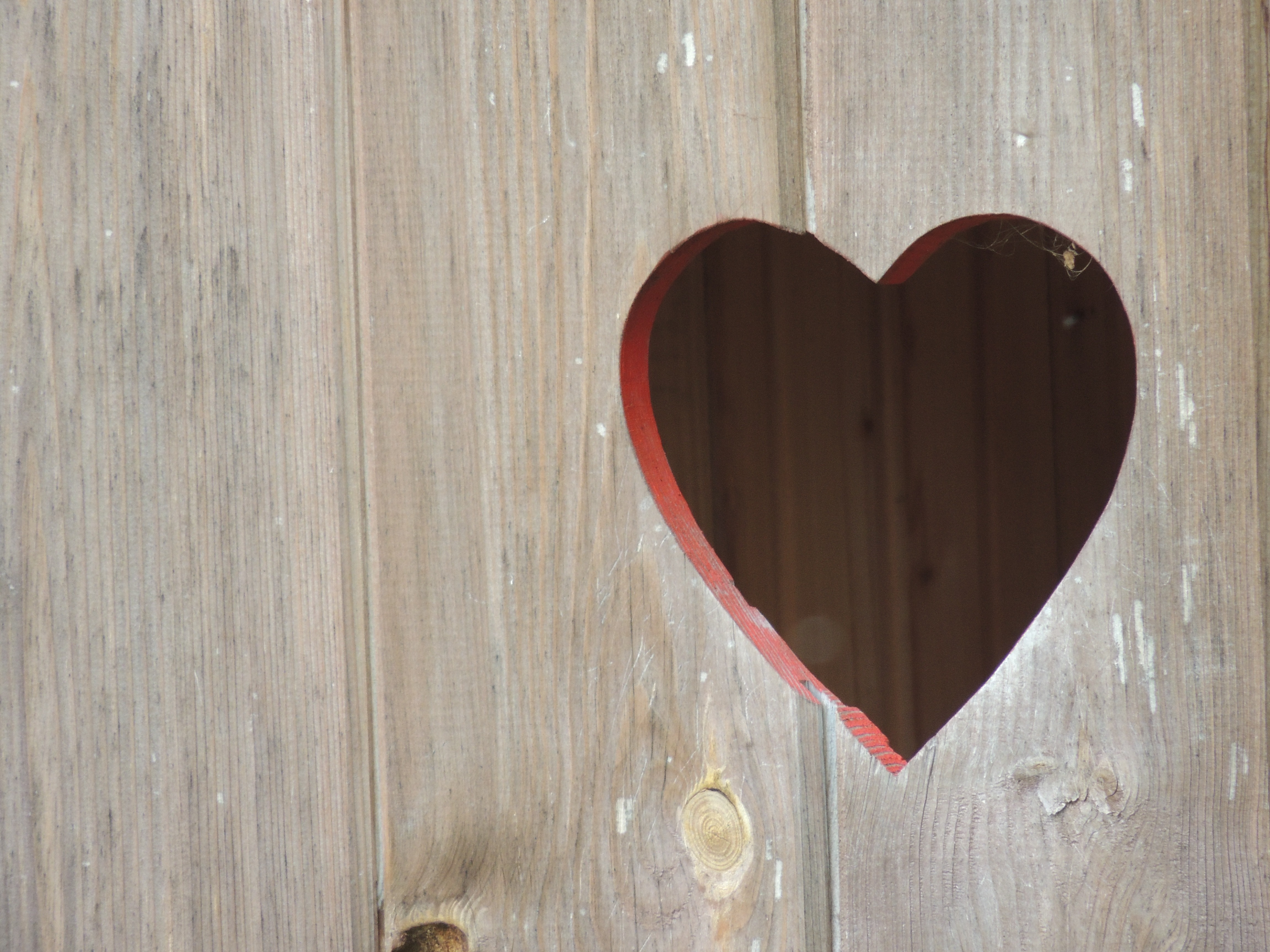 brown wooden wall with heart hole