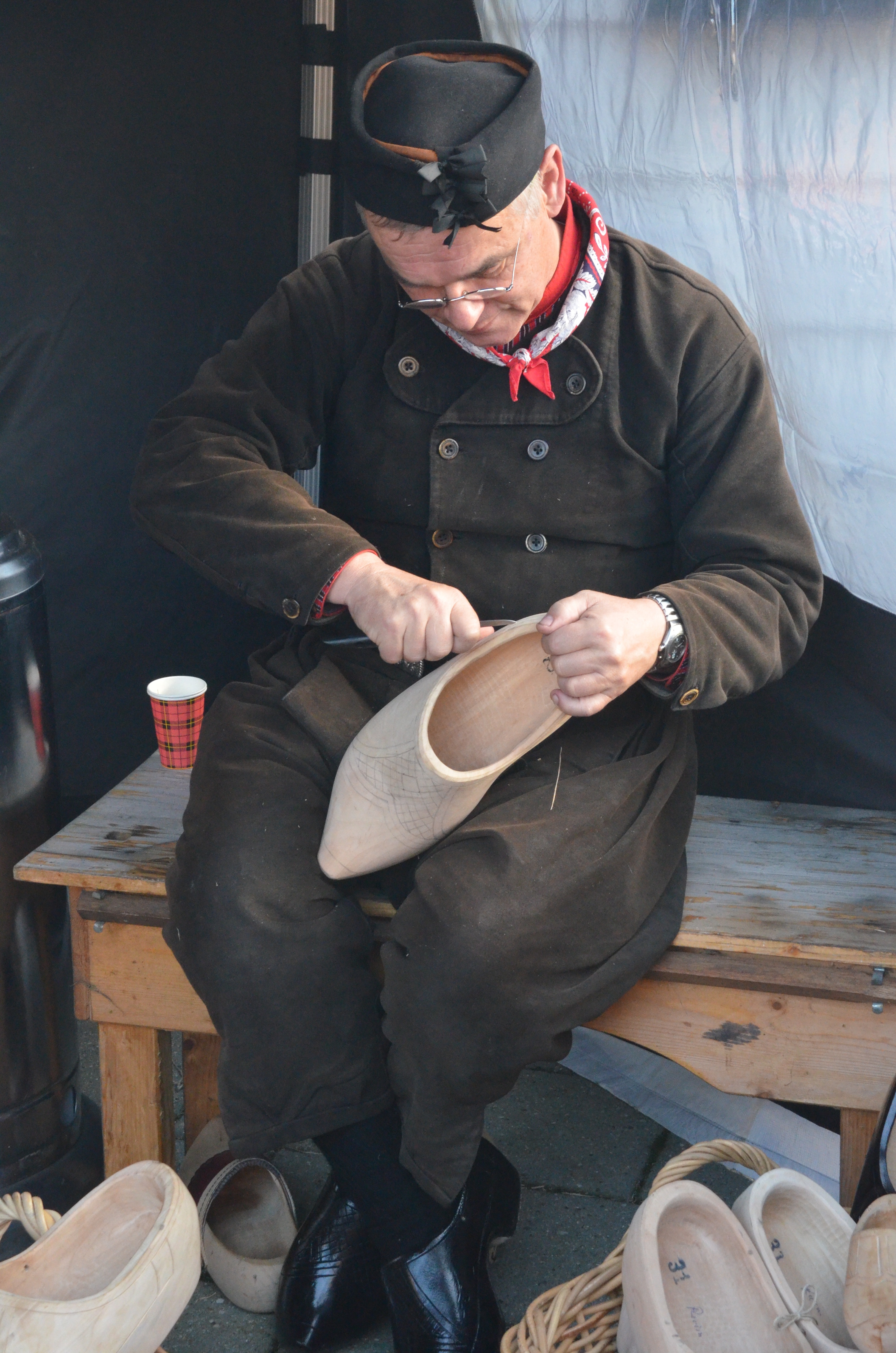 man's beige carved  wooden shoes