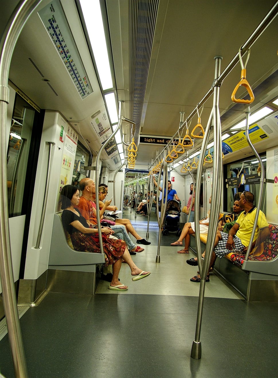 person sitting and standing in train preview
