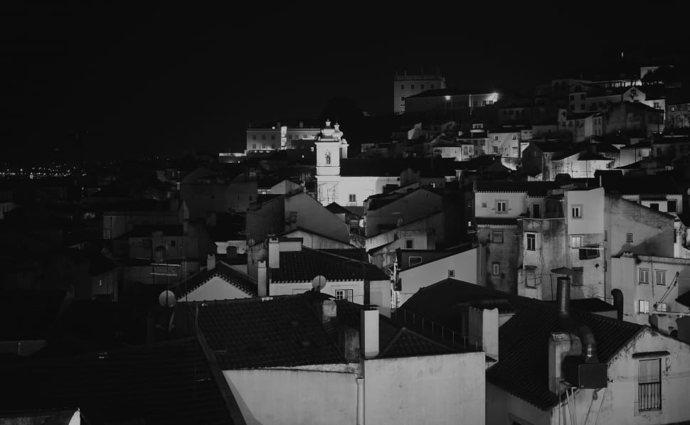grayscale photography of houses during night preview