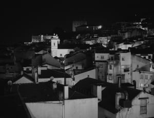 grayscale photography of houses during night thumbnail