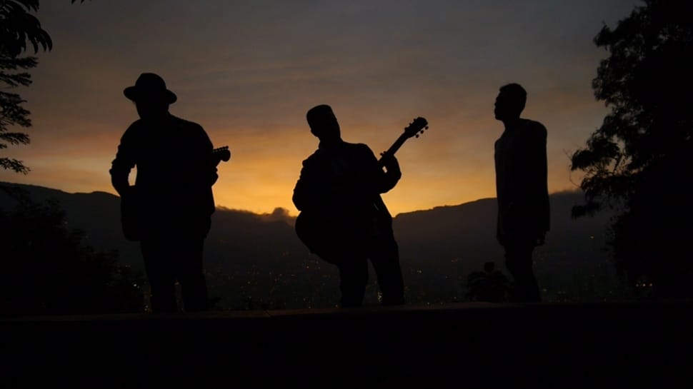 3 man playing musical instruments during sunset picture preview