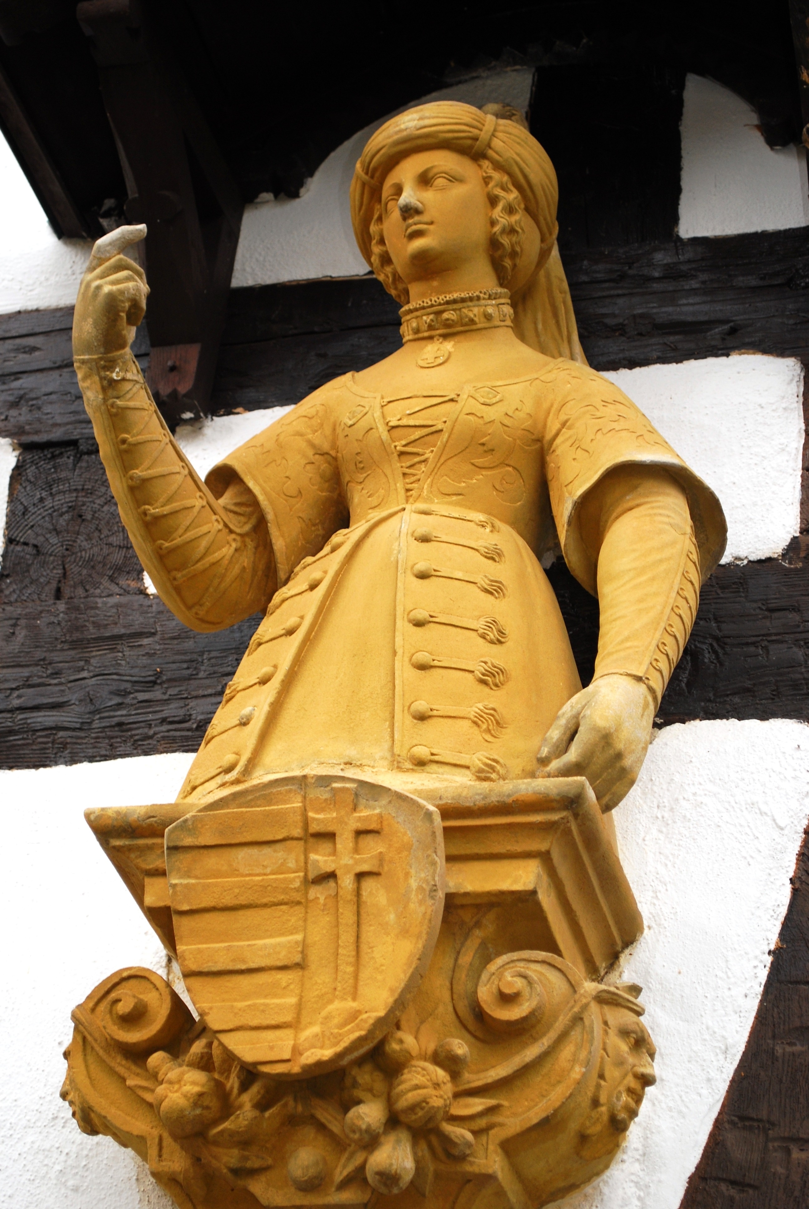 yellow woman in dress statue