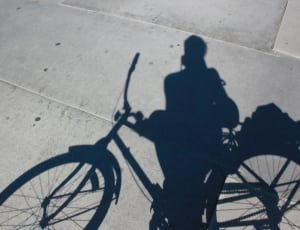 shadow of woman with cruiser bike thumbnail