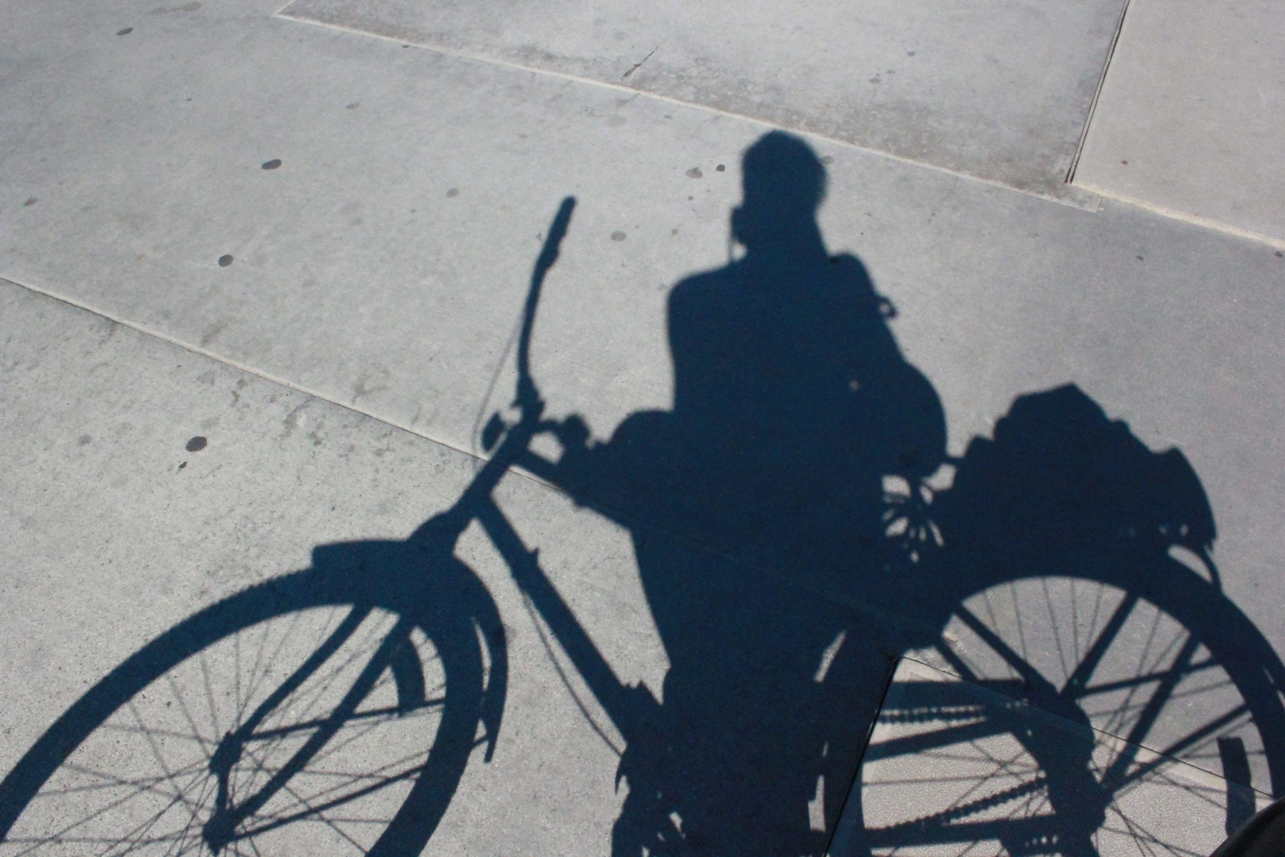 shadow of woman with cruiser bike