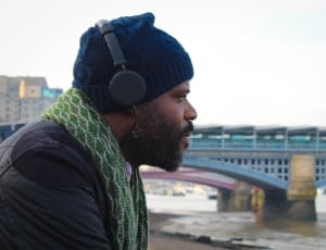 black corded headphones and blue knit cap thumbnail