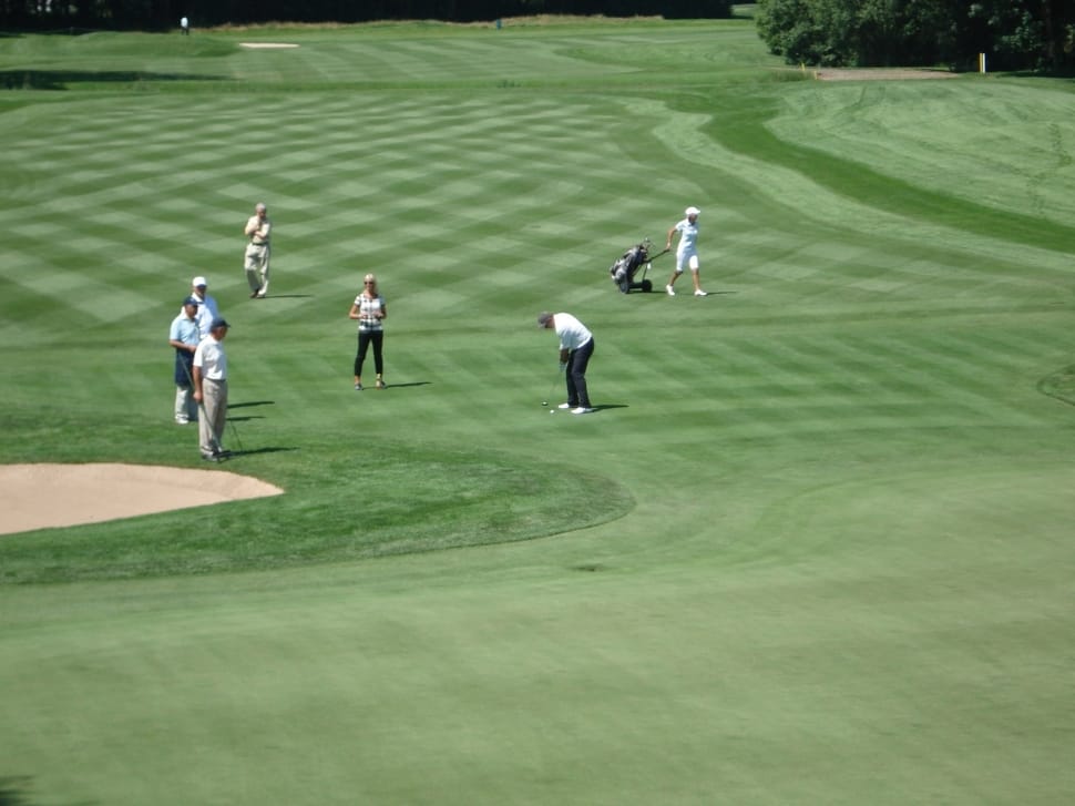 aerial photography of people playing golf on green grass field during daytime preview