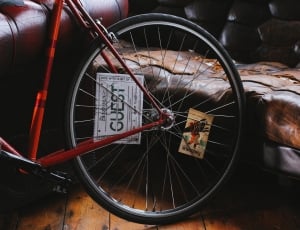 red and black road bike near brown leather couch thumbnail