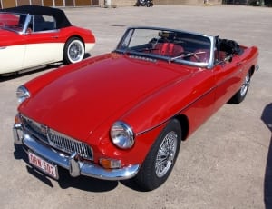 red classic MG roadster thumbnail
