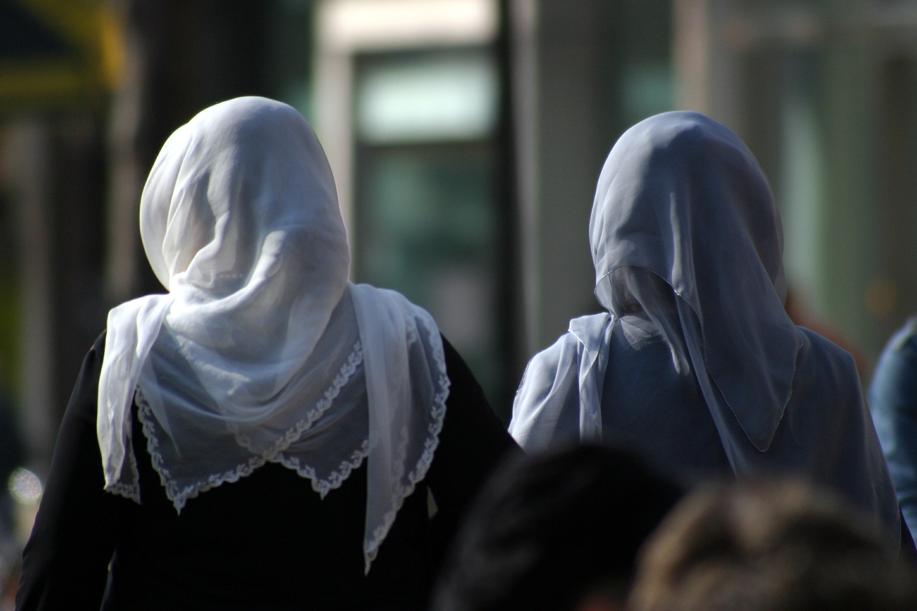women's black abaya and white hijab