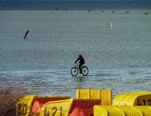 black bicycle and body of water thumbnail