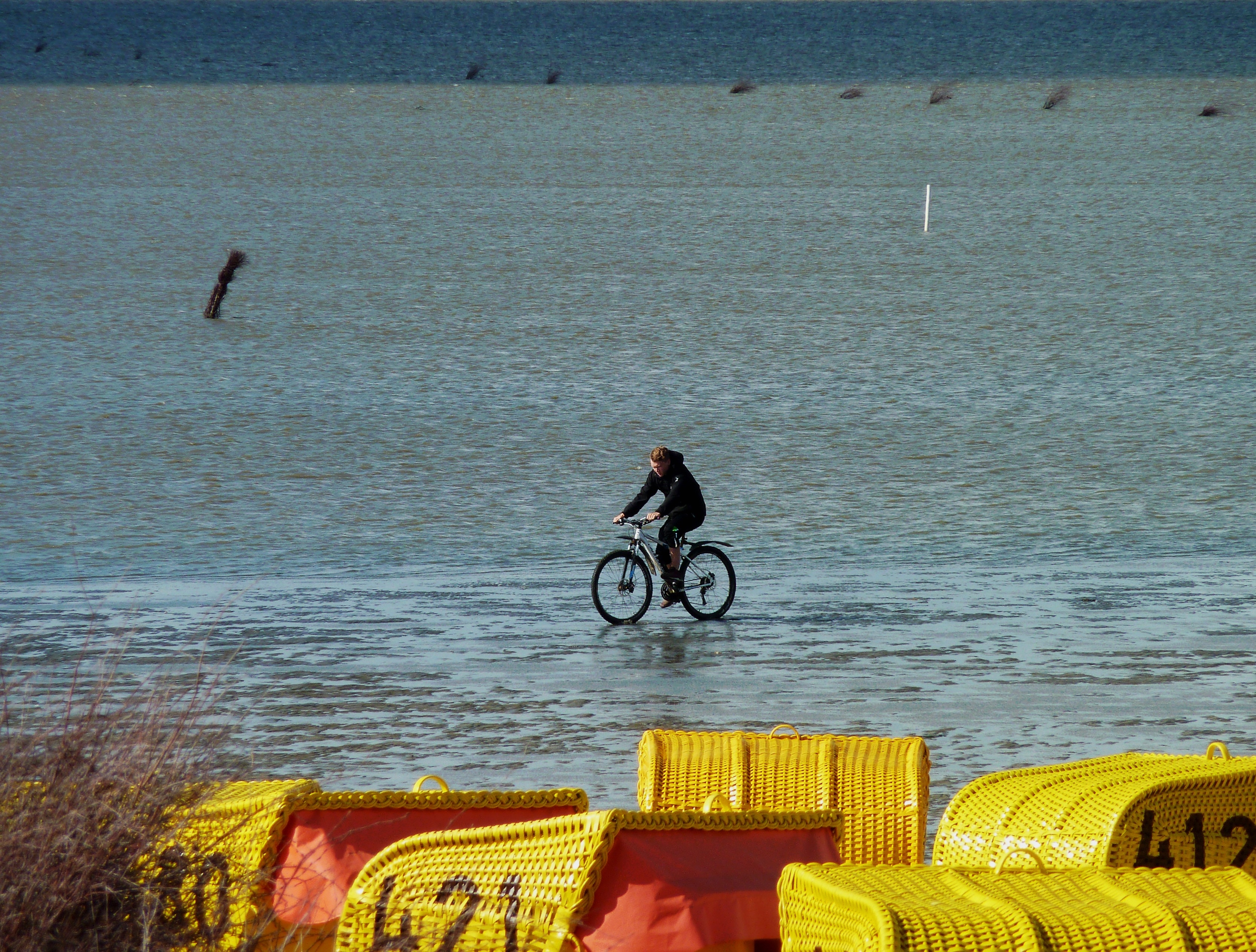 black bicycle and body of water