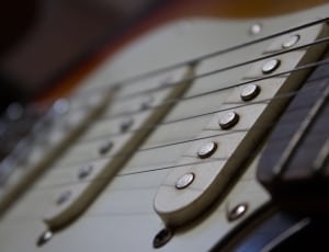 brown and white electric guitar thumbnail