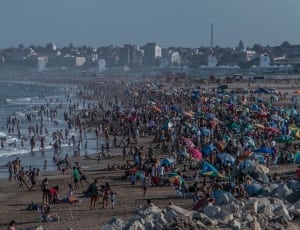 lot of people standing beside beach thumbnail