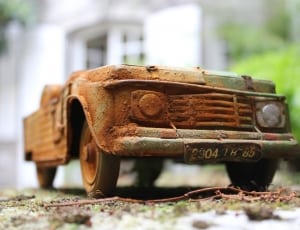brown and green old car figurine thumbnail