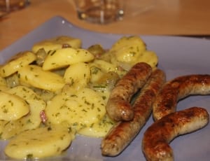 sausages with sliced potato dish thumbnail