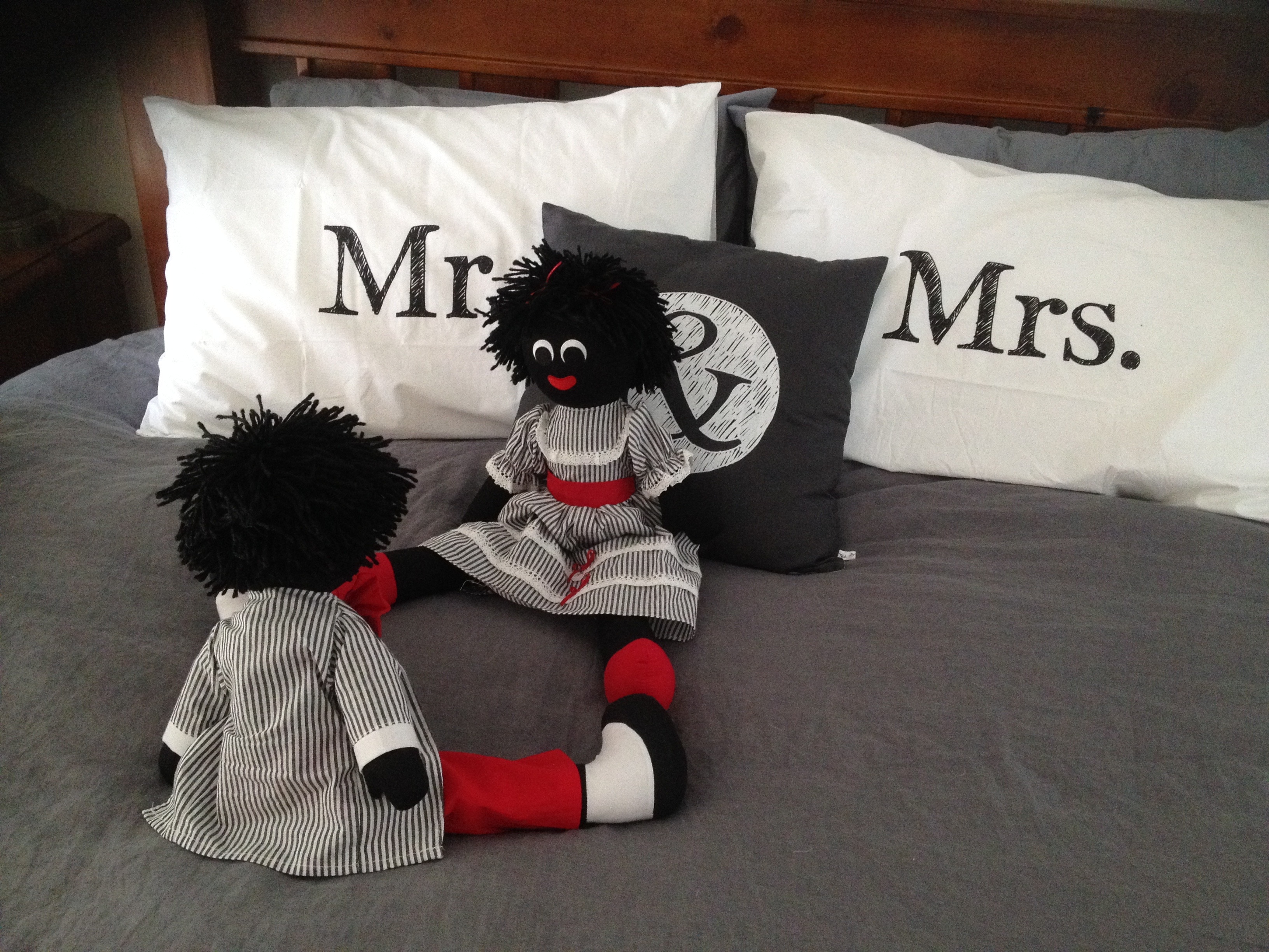 2 black and red plush toy and mr and mrs pillows