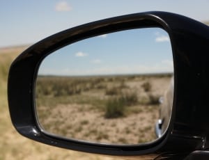 black car side mirror on desert thumbnail