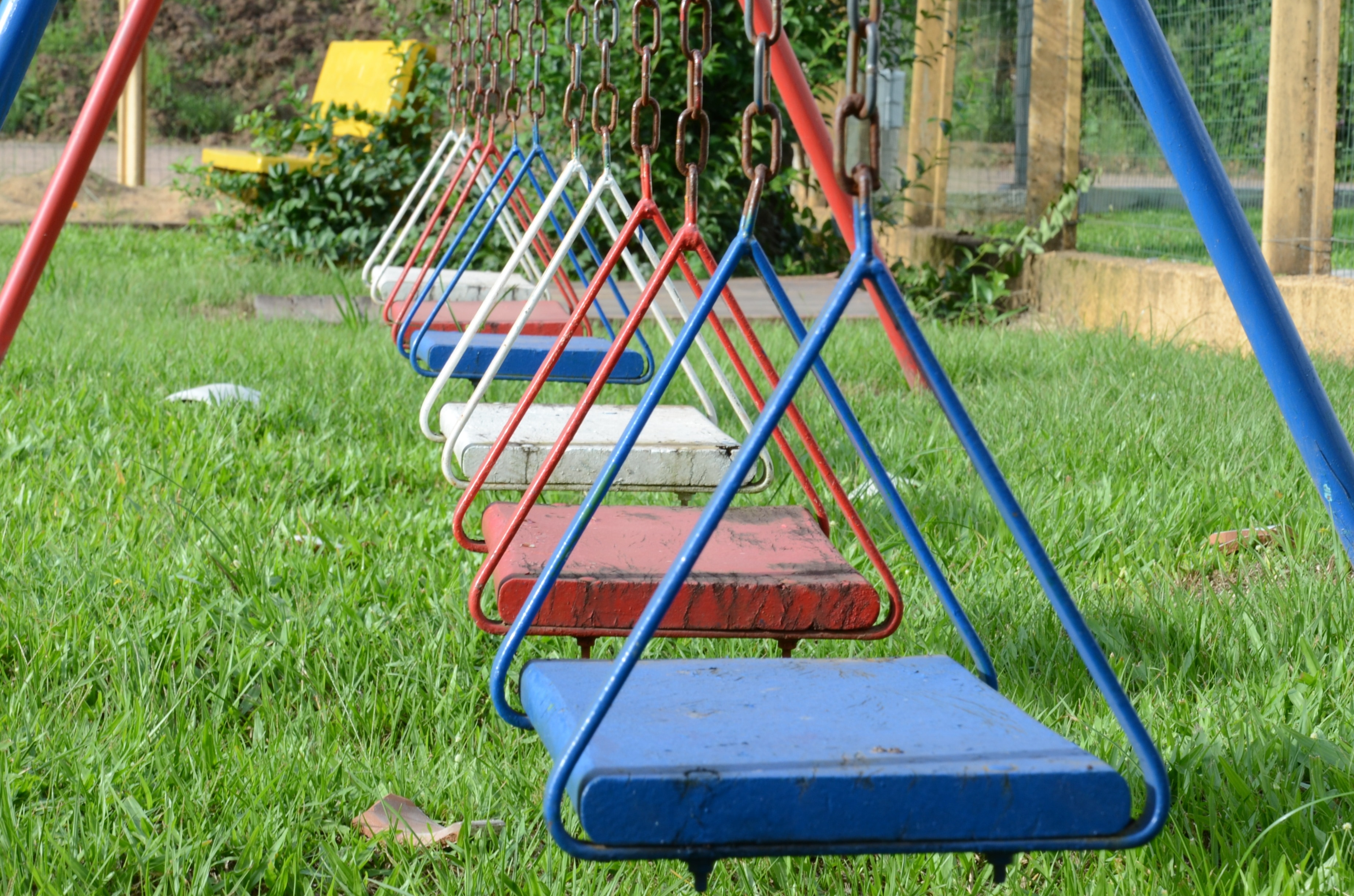 red, blue and white metal swings