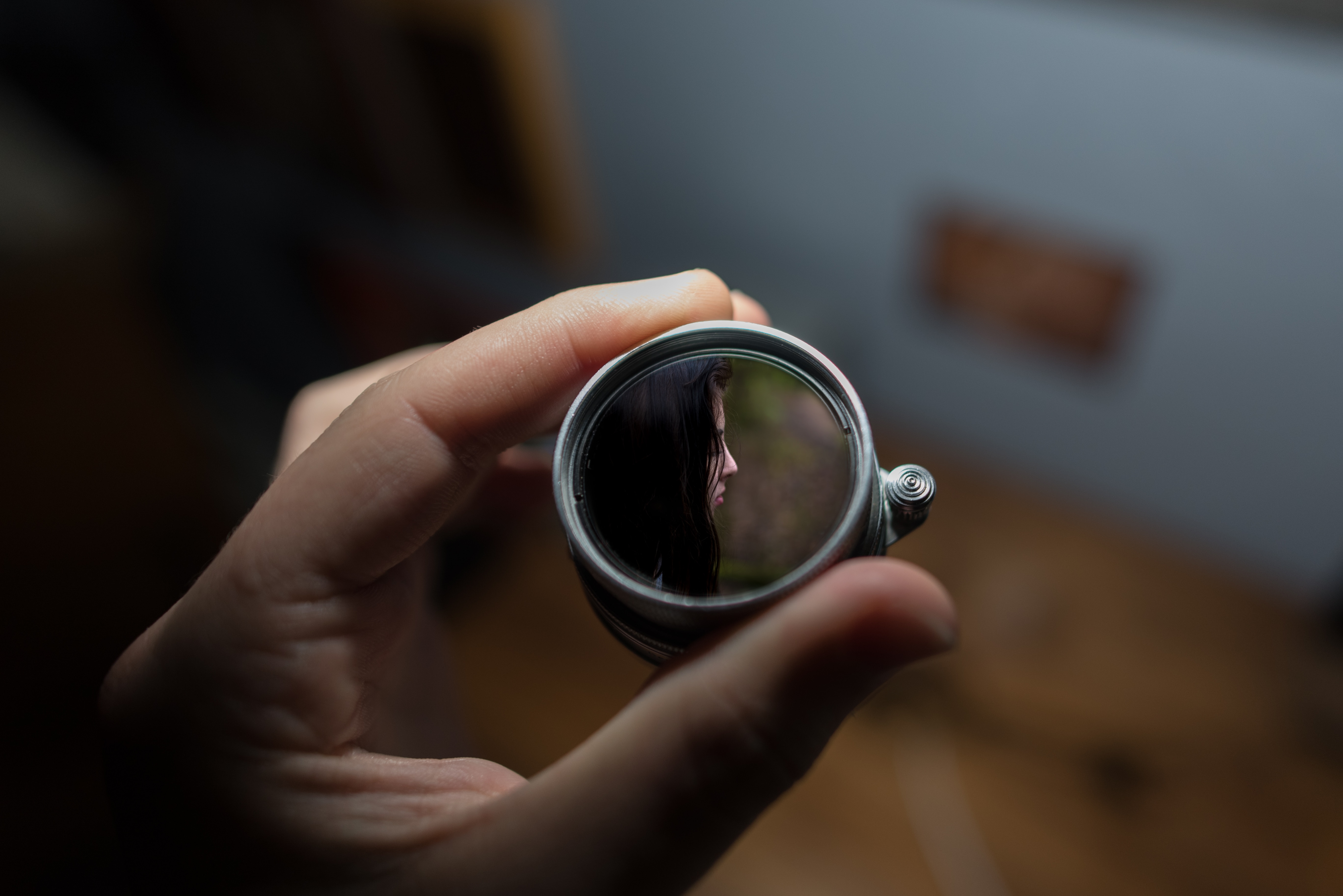 shallow focus photography of silver round device showing woman