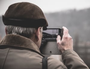 man holding smartphone taking photo thumbnail