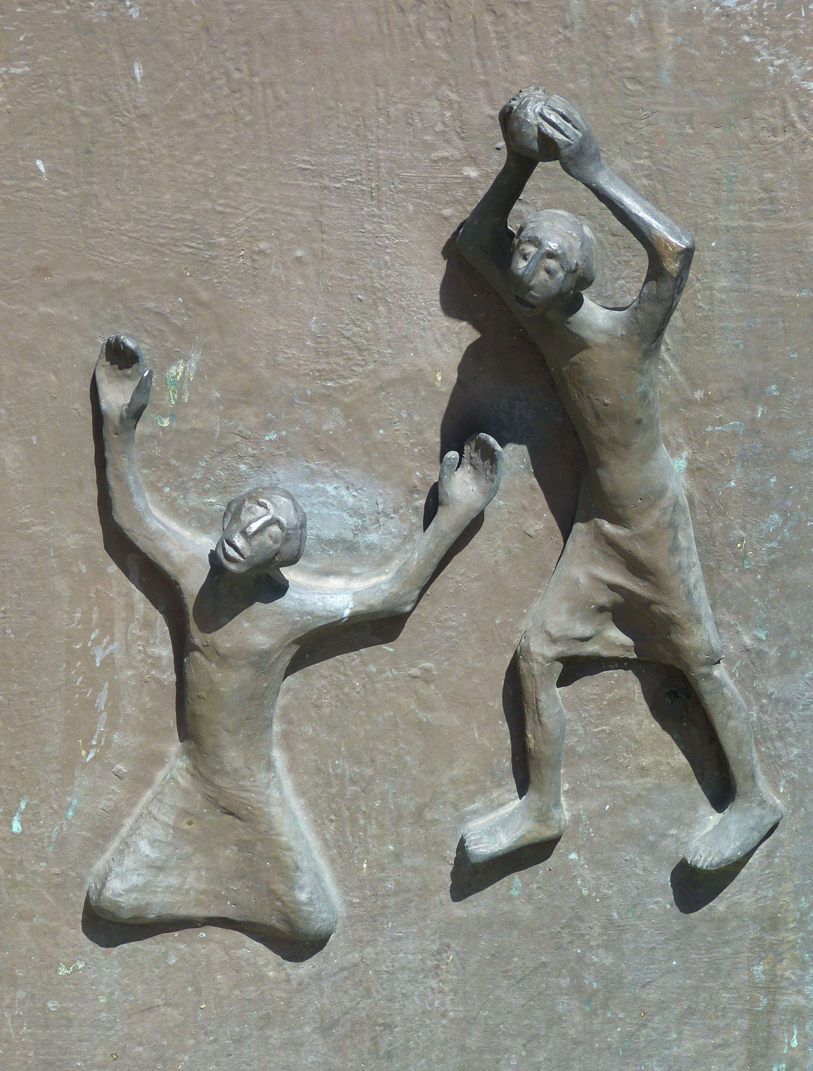 two person raising hands sculpture