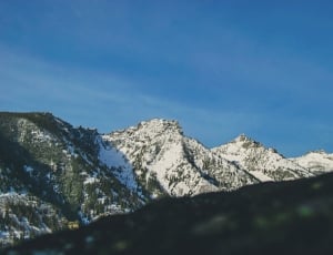 white and green mountain under blue sky during golden hour thumbnail