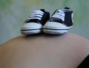baby's pair of black converse sneakers thumbnail