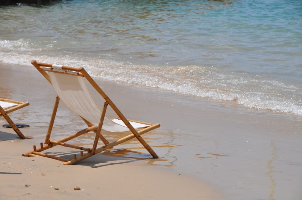 brown wooden beach lounge chair on sea shore during daytime preview