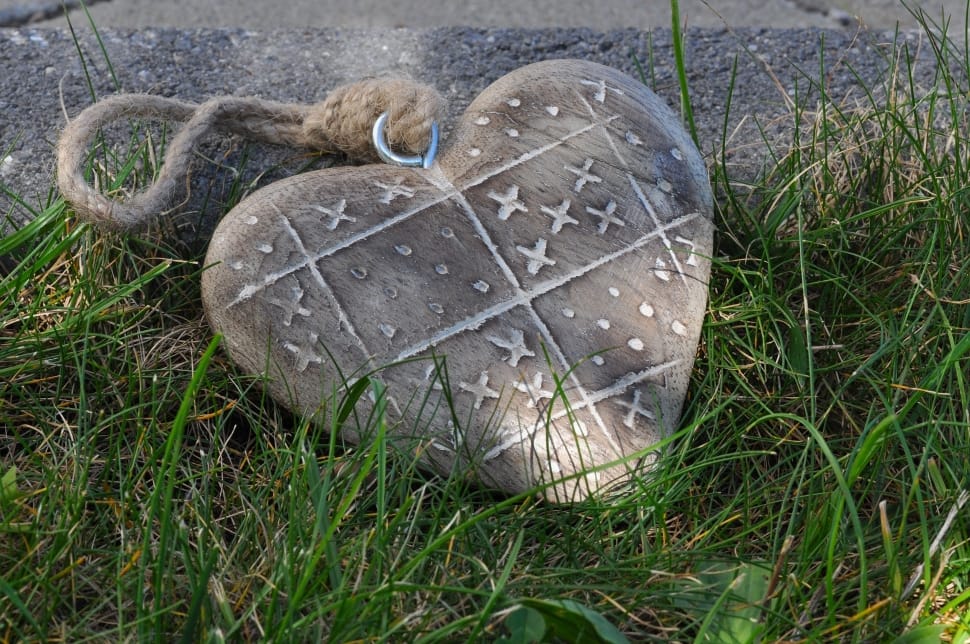 gray heart shape hanging decor on green grass surface preview