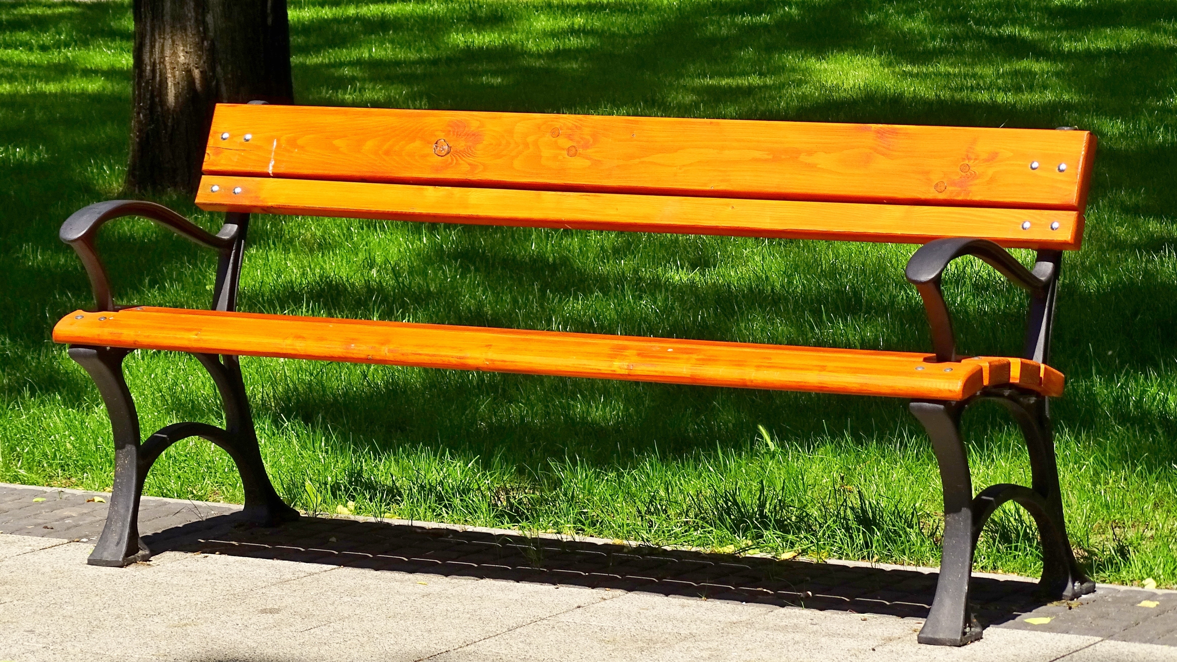 black metal framed brown wooden outdoor bench