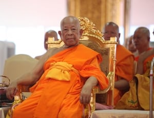 monk sitting on gold armchair thumbnail