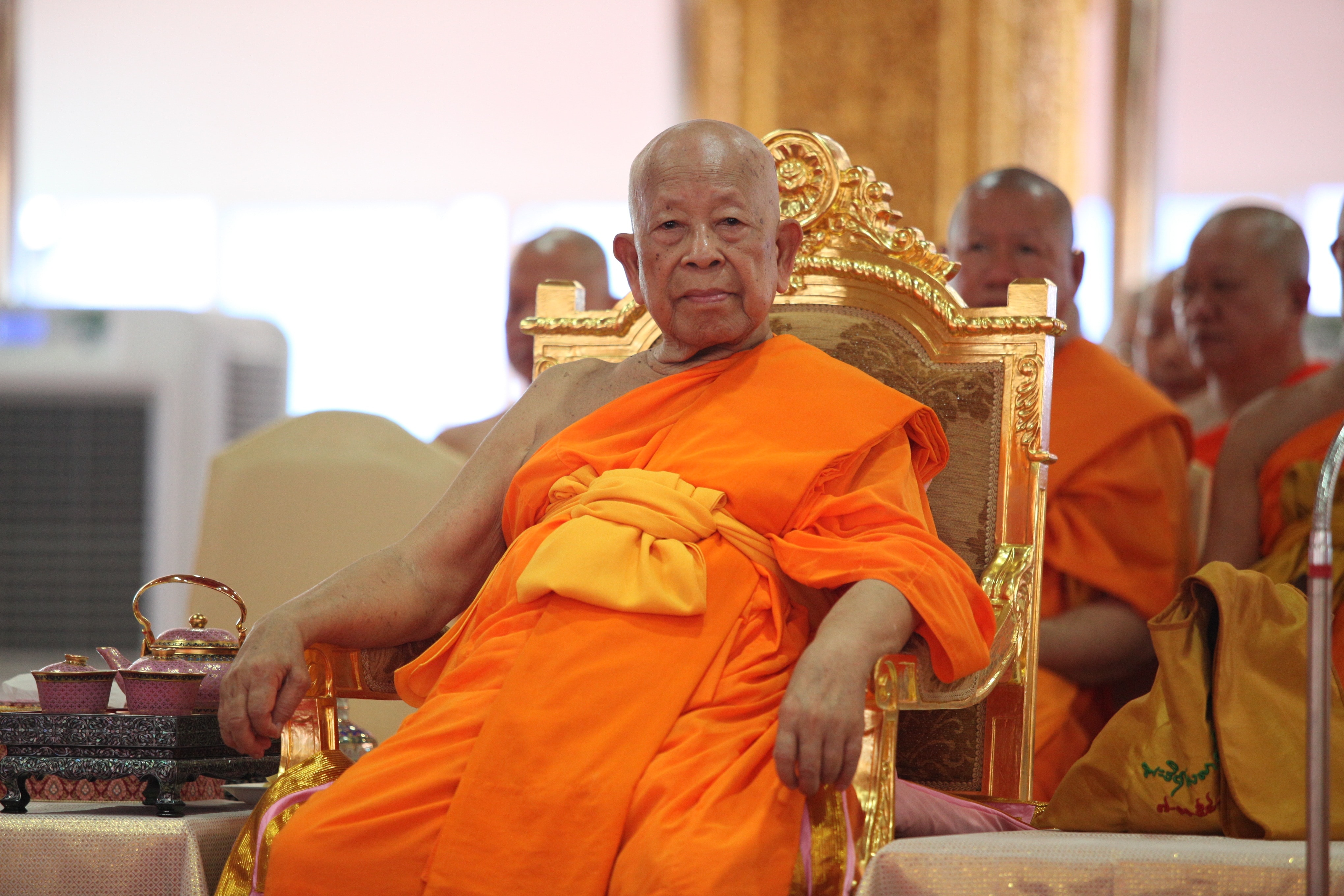 monk sitting on gold armchair