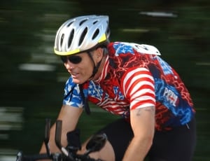 men's blue and red shirt and grey bicycle helmet thumbnail