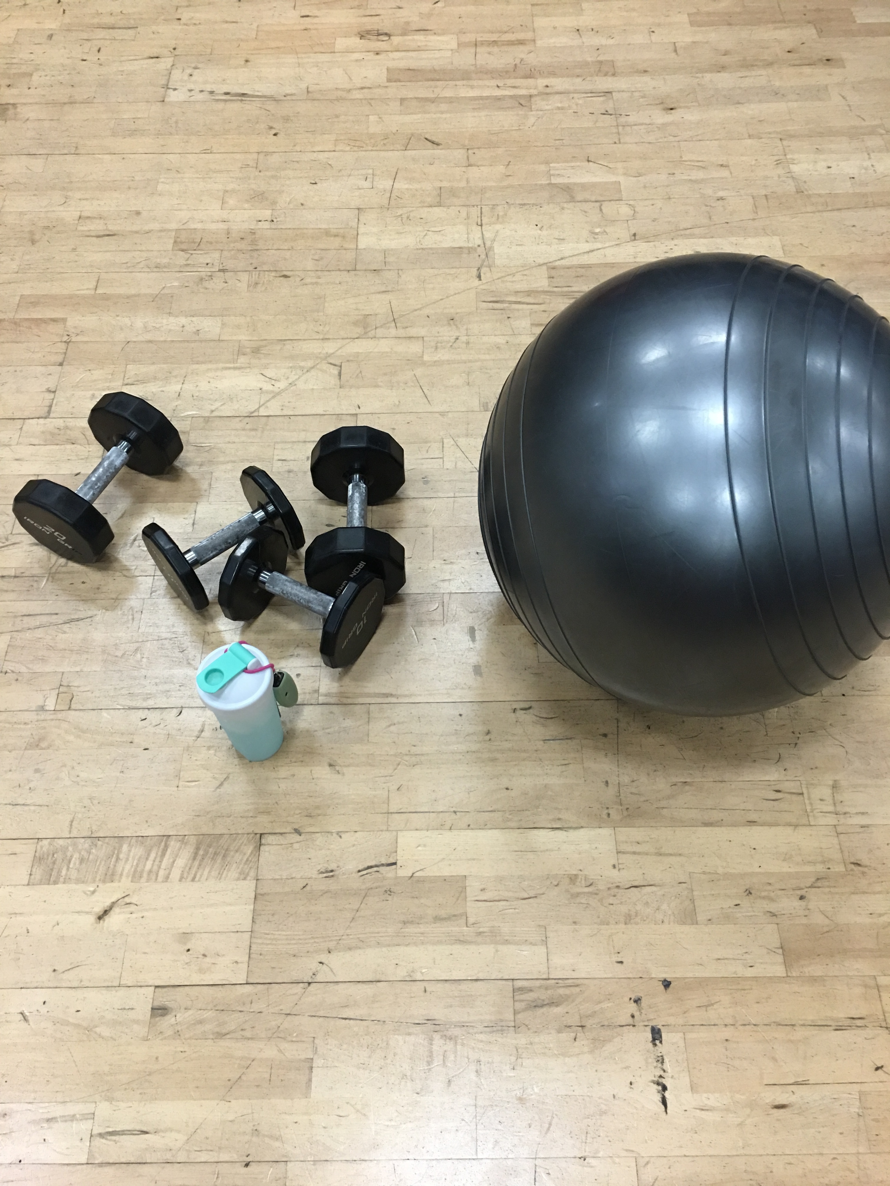 black stability ball and pair of dumbbells