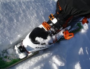 green white black and orange printed snow ski thumbnail