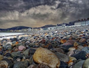 sea bay with stones and white painted buildings thumbnail