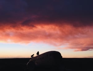 silhouette of two person on top plane thumbnail