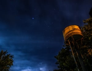 midnight photography of water tank under starry night thumbnail