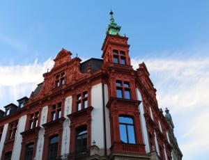 brown and white building with green tower thumbnail
