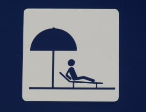 man figure on lounger under umbrella illustration thumbnail