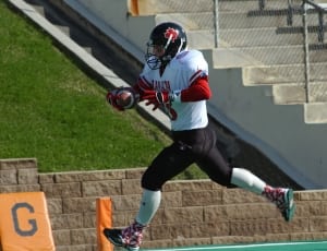 football player running wearing black helmet with red maple leaf logo thumbnail
