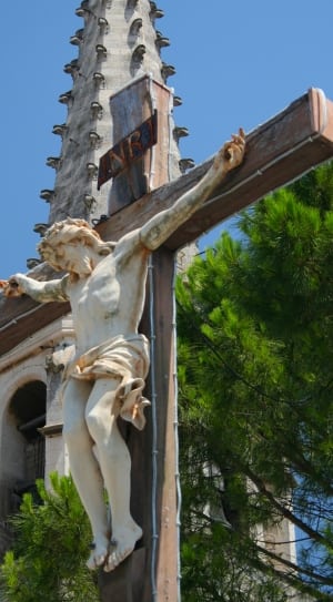 crucifix art near green leaf tree thumbnail