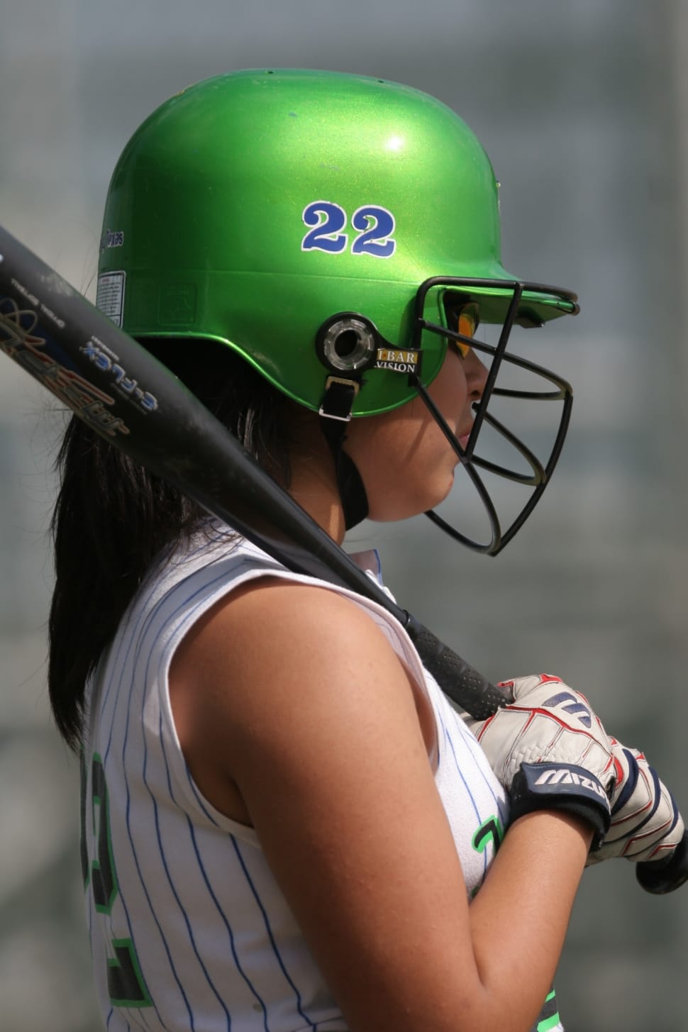 black baseball bat and green 22 print helmet preview