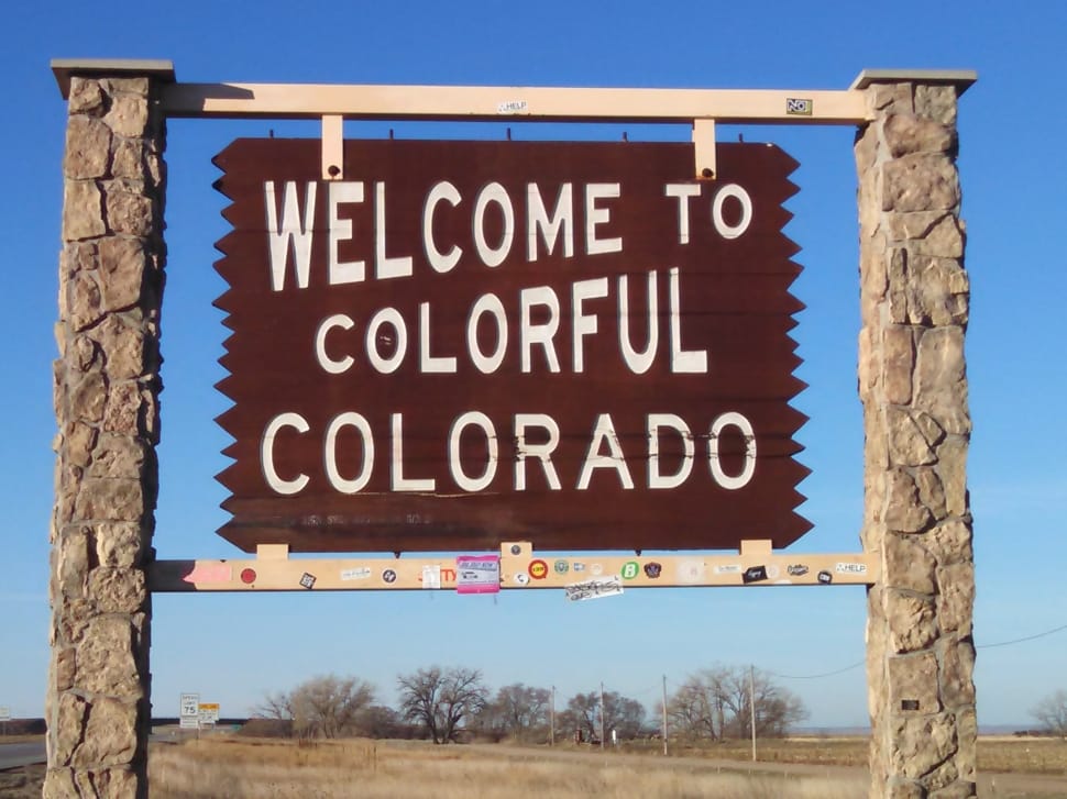 brown wooden welcome to colorful colorado signage preview