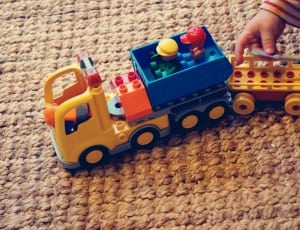 blue yellow orange and red plastic vehicle toy thumbnail