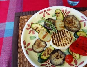 grilled steak, zucchini and tomatoes on white green and pink round plate thumbnail