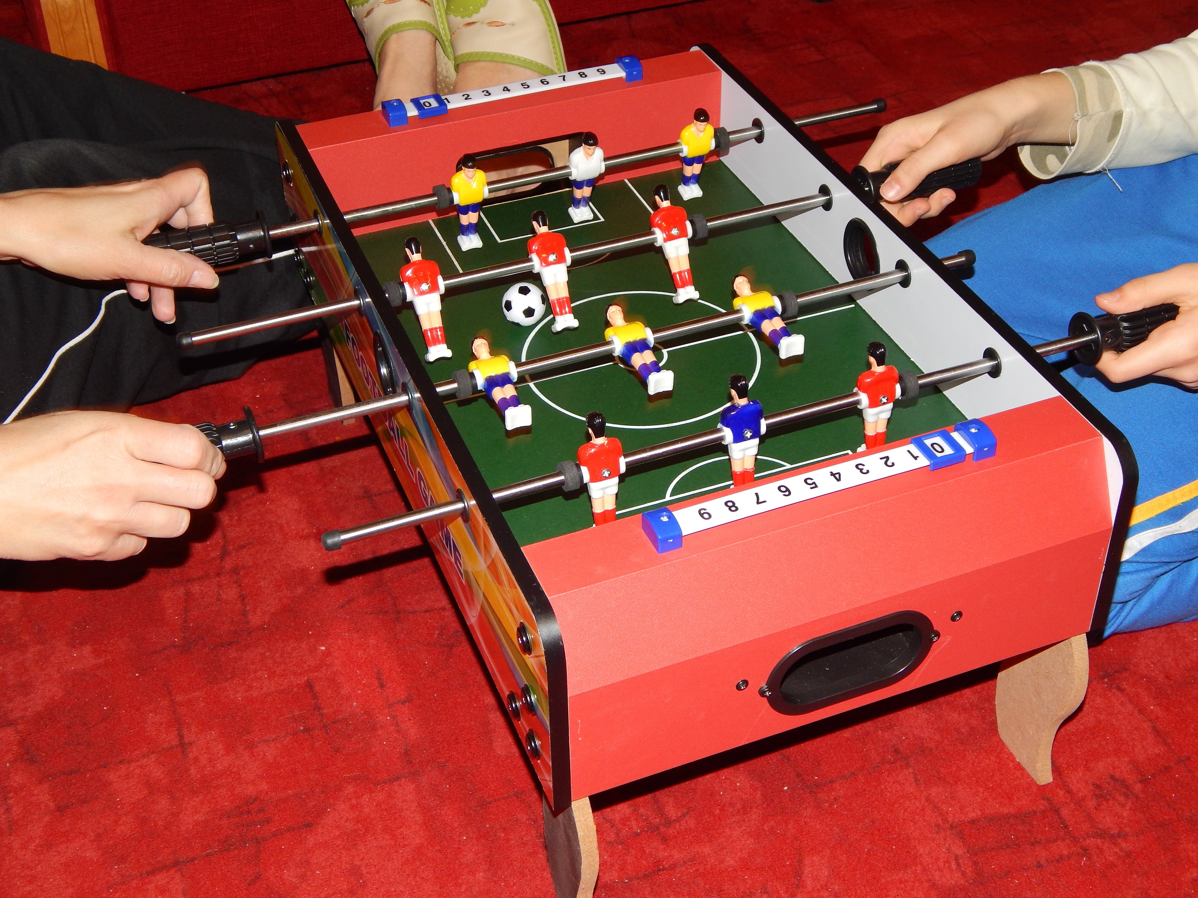 red black yellow and blue fossball table