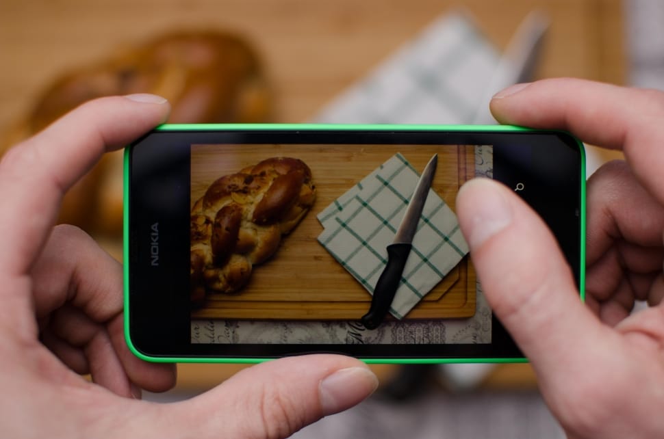 green nokia lumia with knife, napkin and bread on display preview