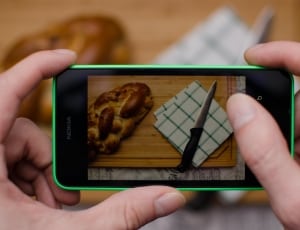 green nokia lumia with knife, napkin and bread on display thumbnail